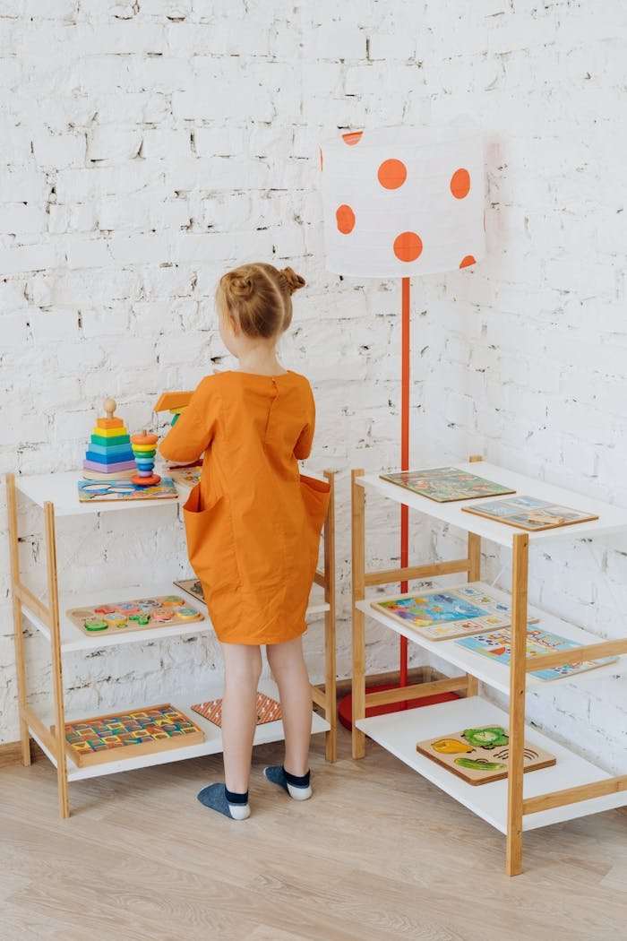 A young girl plays with educational toys in a colorful preschool classroom setting.